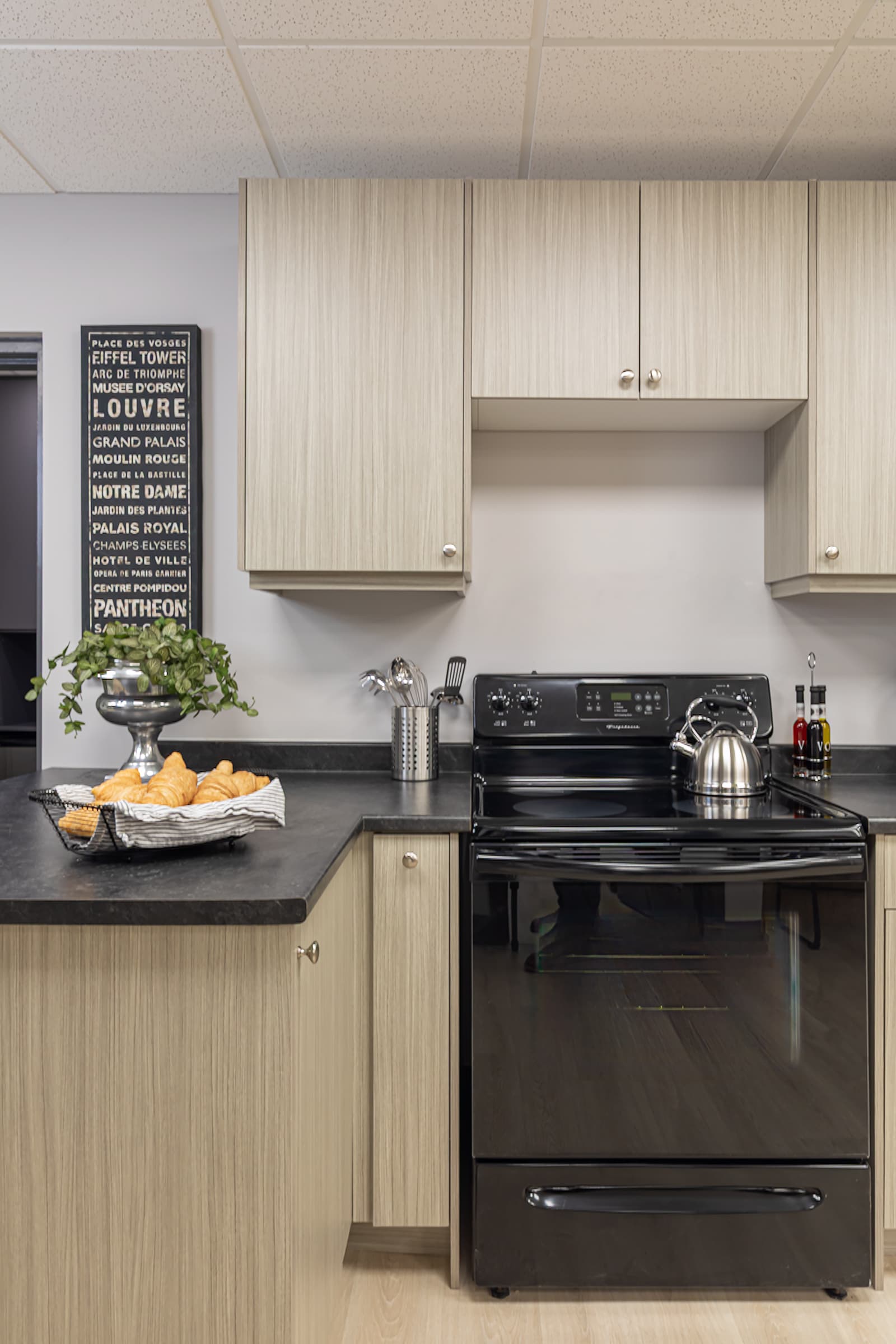 front view of kitchen cabinetry and black stove